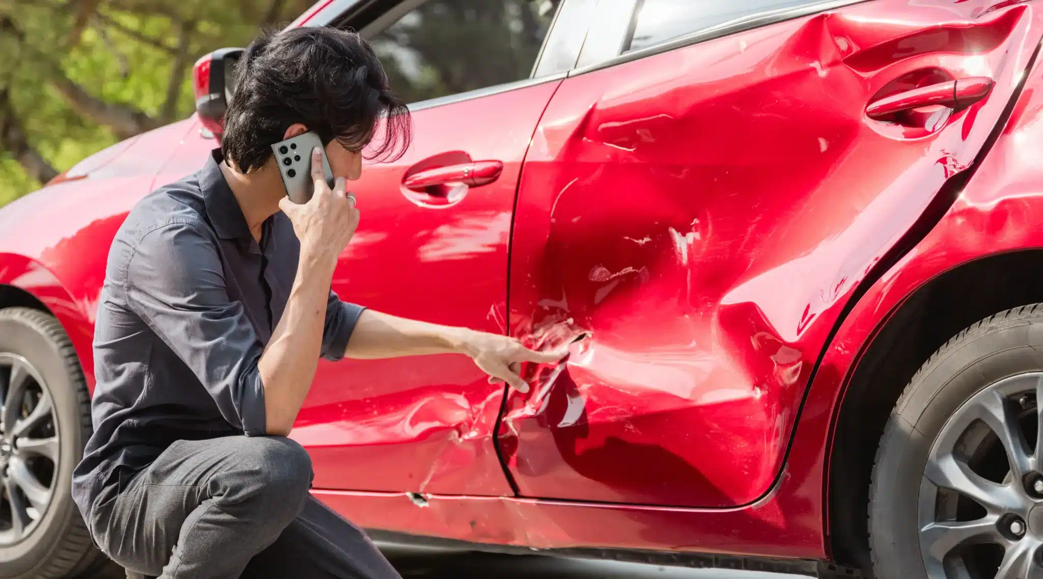 Man investigating his car after an accident