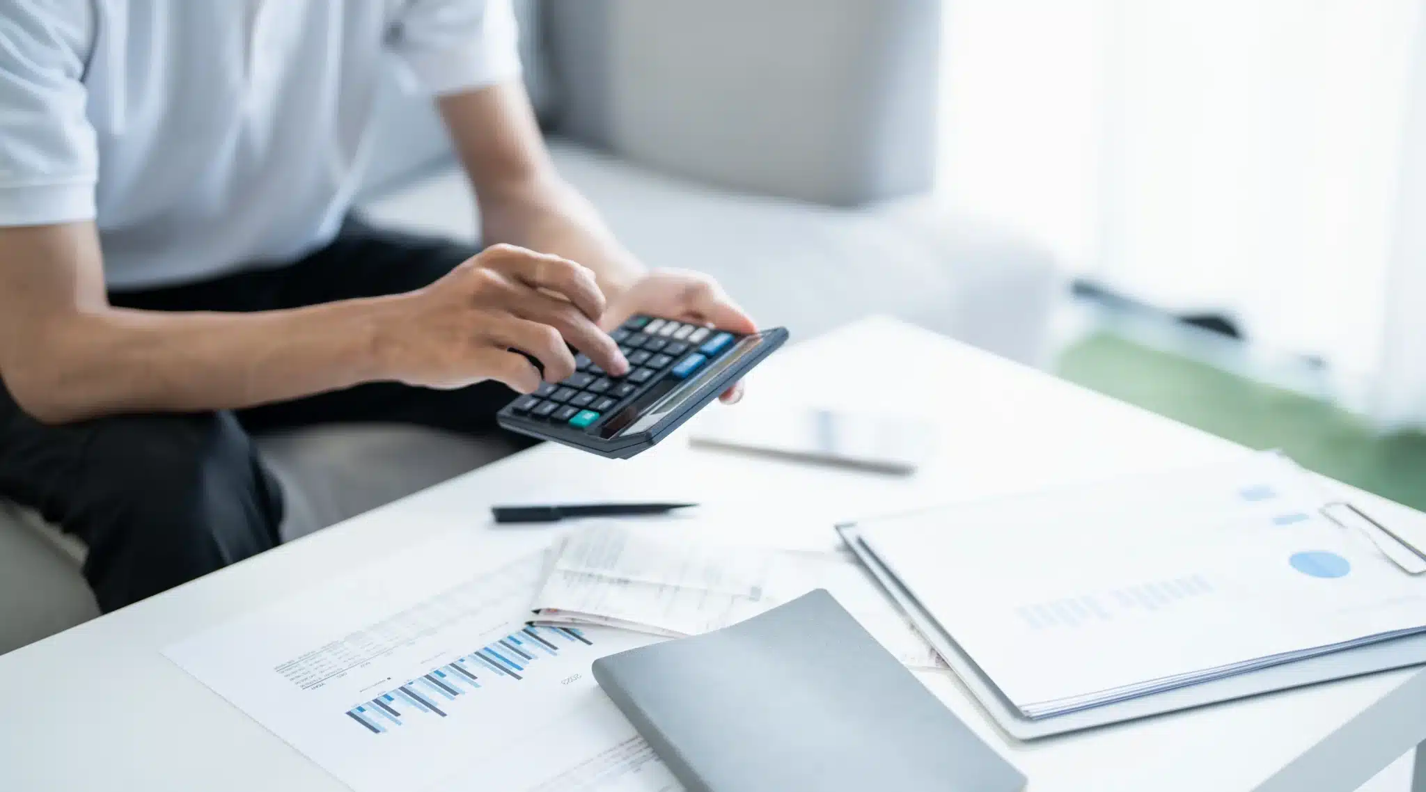 Man calculating his wages on a calculator